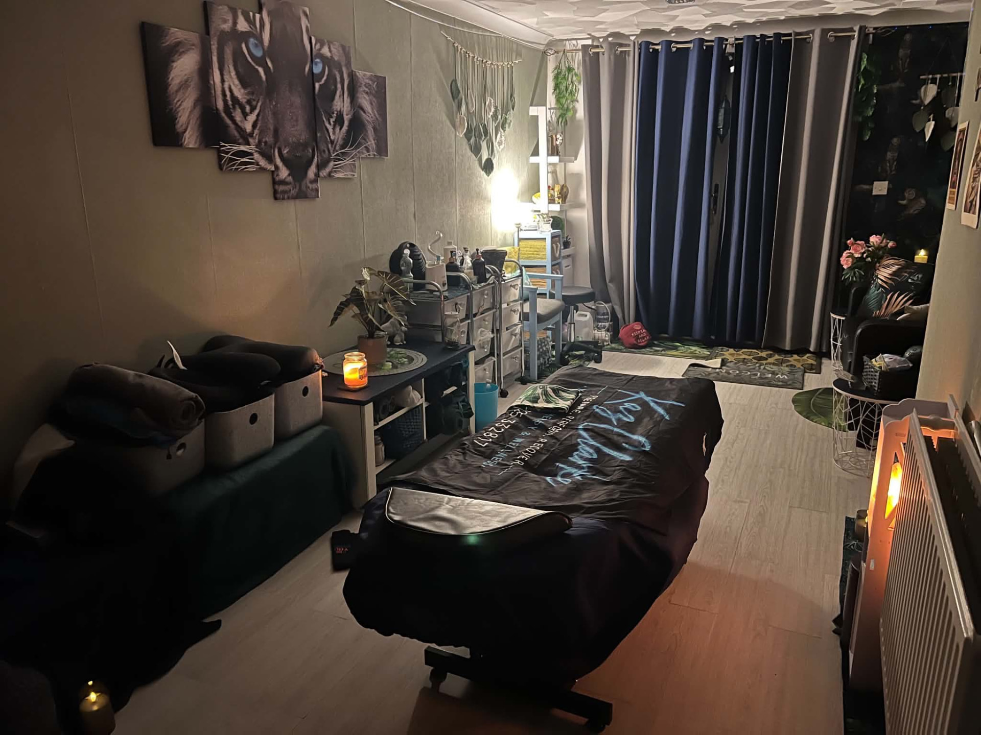 Candlelit massage treatment room with tiger artwork